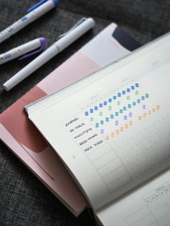 Woman writing in health journal tracking cycle patterns