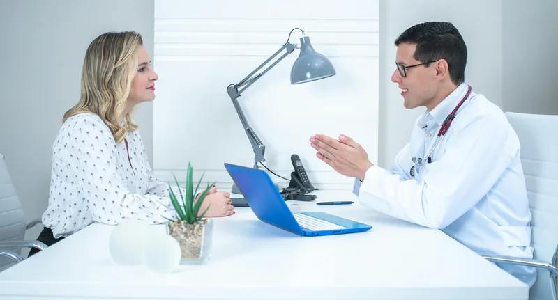 Medical consultation reviewing thyroid function and hormone test results