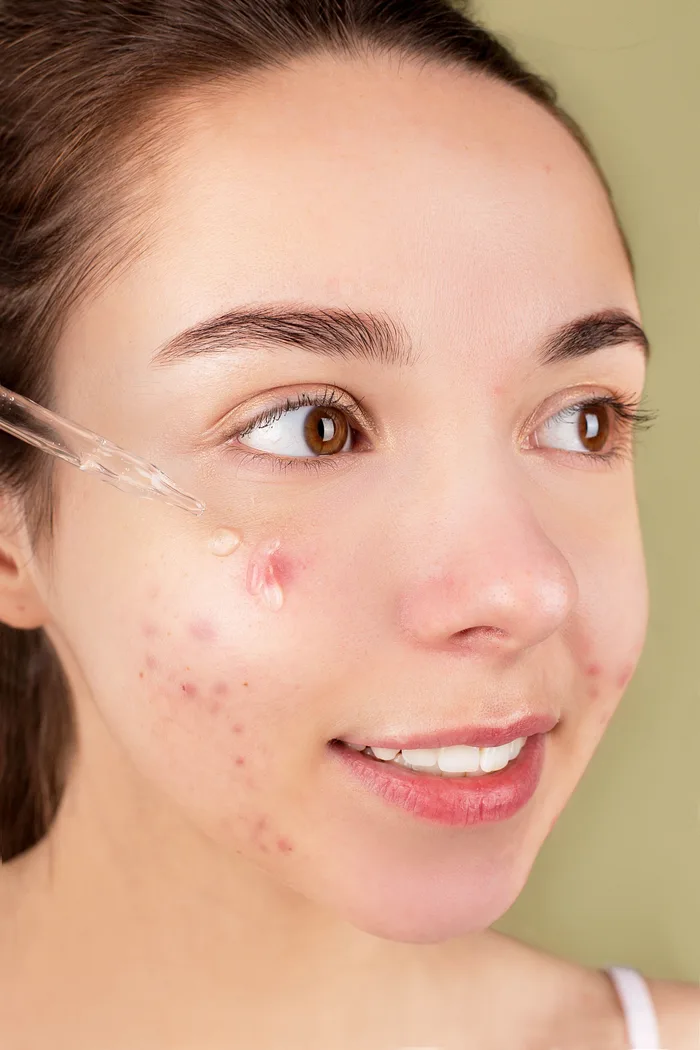 Woman examining skincare ingredient list closely