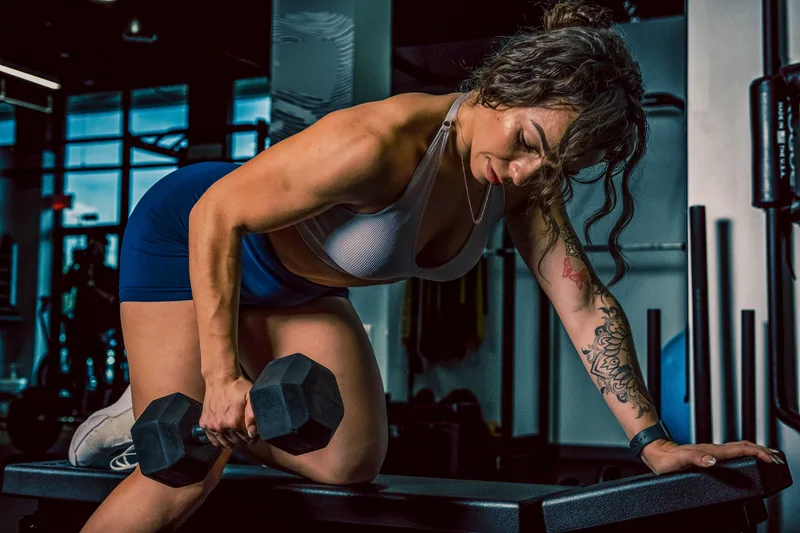 Woman performing resistance training to build and preserve muscle mass
